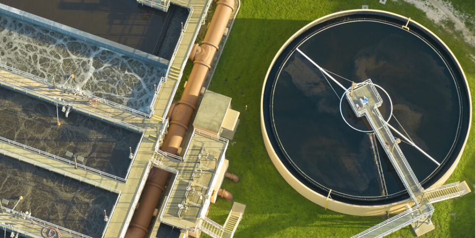 Aerial view of modern water cleaning facility at urban wastewater treatment plant. Purification process of removing undesirable chemicals, suspended solids and gases from contaminated liquid